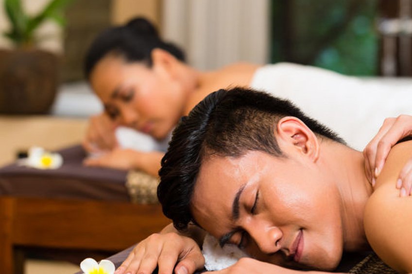 Happy couple indulging in a relaxing couple massage at The Outcall Spa