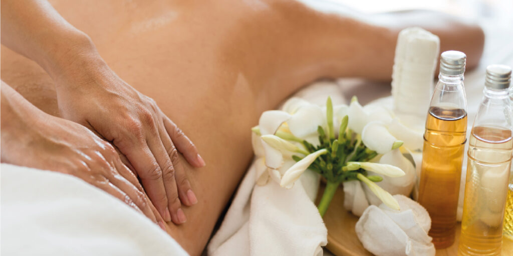 A serene spa setting with candles and flowers, creating a peaceful ambiance for self-care and relaxation.