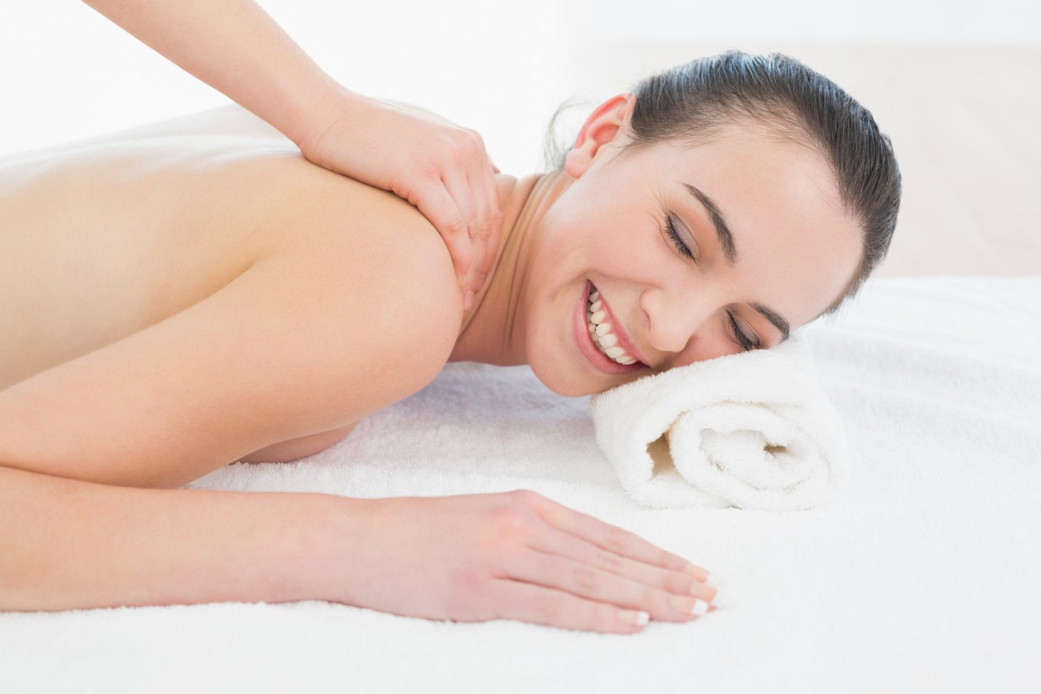 Close up of a beautiful woman enjoying back massage at beauty spa